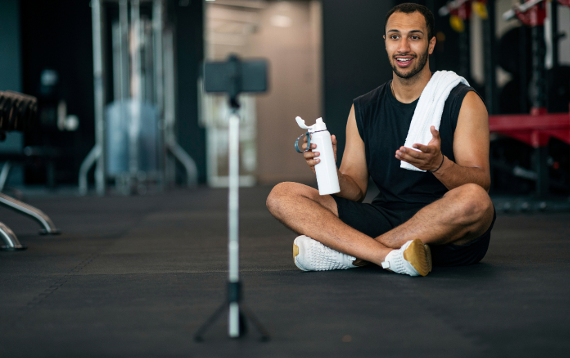 Fitness influencer filming a video at the gym showcasing loyalty-building strategies for eCommerce brands.